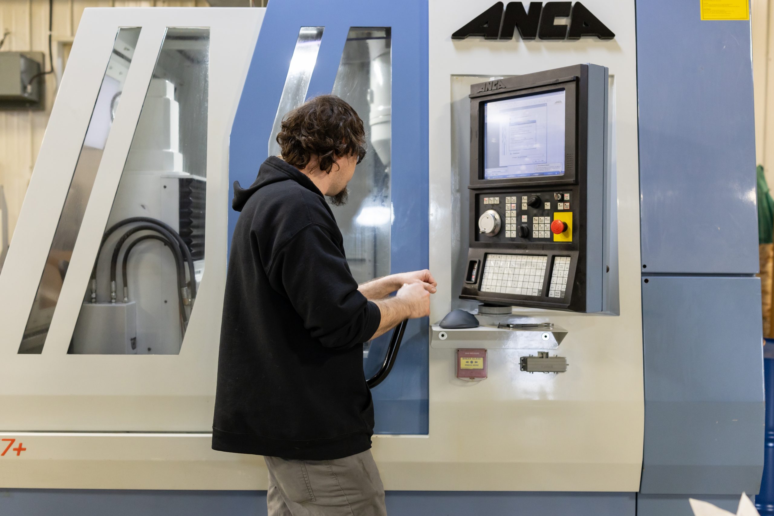 Machinist operating a CNC machine at Veit Tool Machinist operating a CNC machine at Veit Tool’s precision machining facility in Davison, Michigan.